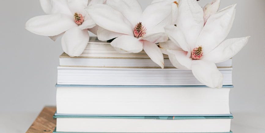 Editorial workspace with books and flowers